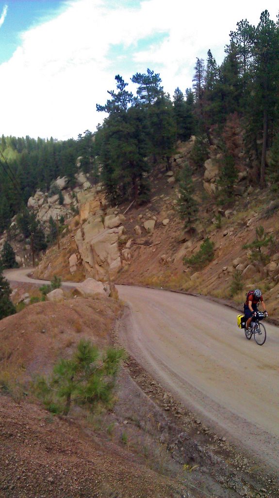 Elliot grinding up the steep, gravely West Pine Creek Road