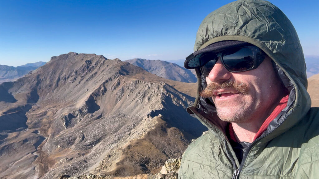 Taking a break in the BD Solution Hoody on Mt. Columbia during one of many Nolan's 14 scouting missions. 