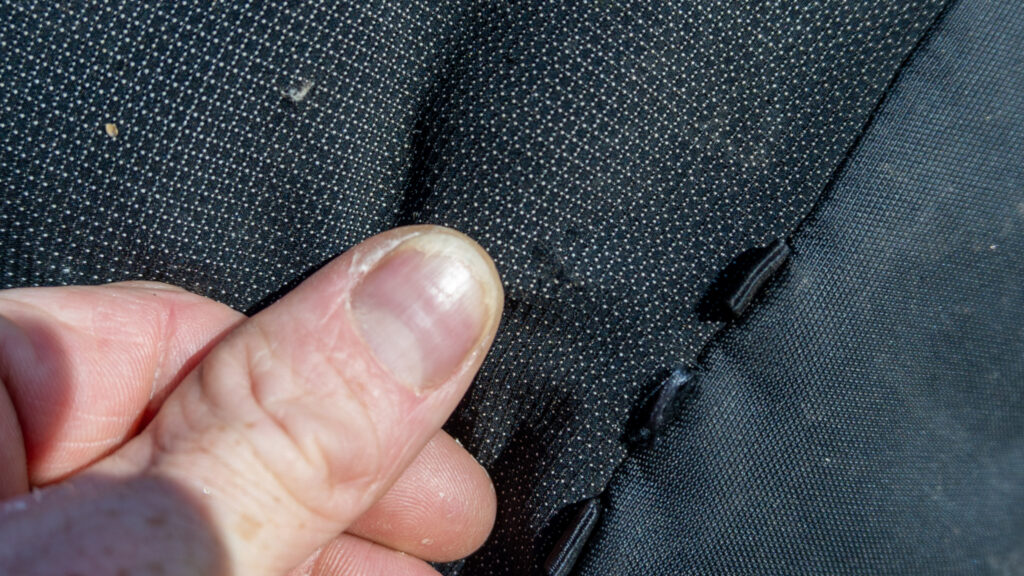 After months of use and abuse of the Grit 28, I found only a small fuzzy spot in the bottom of the center pocket -- LOVE this material!
