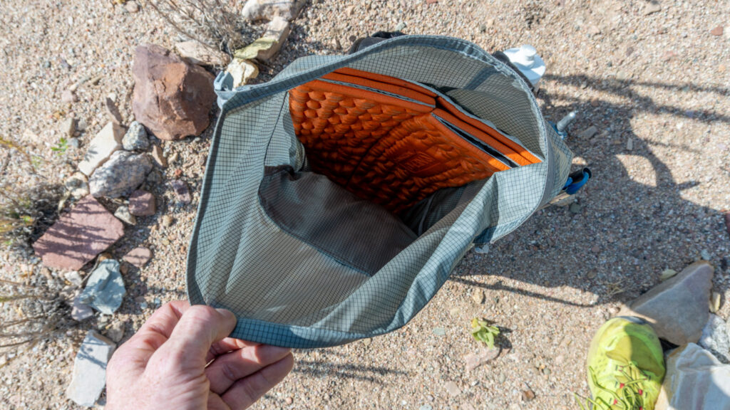 I sometimes opt to leave the included back padding at home, and use a few panels of a CCF pad instead. The CCF pad is taller than the pack, so I just bend it to lay on the floor of the pack